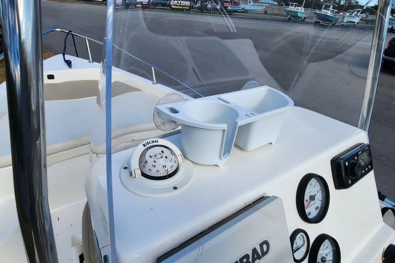 Slide: The Image of 2017 Key West 1720 Center Console boat dashboard with compass and gauges. - 11