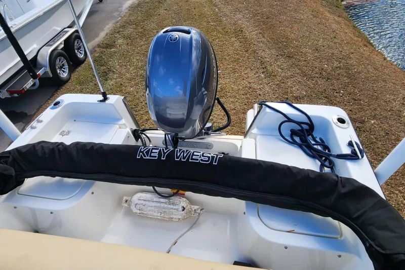 Slide: The Image of 2017 Key West 1720 Center Console boat with Yamaha outboard motor, docked on grass. - 14