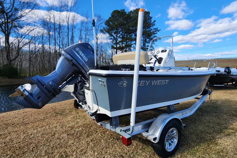 Slide: The Image of 2017 Key West 1720 Center Console boat with Yamaha engine on trailer, outdoors. - 2