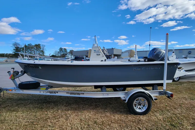 Slide: The Image of 2017 Key West 1720 Center Console boat on trailer under blue sky. - 7