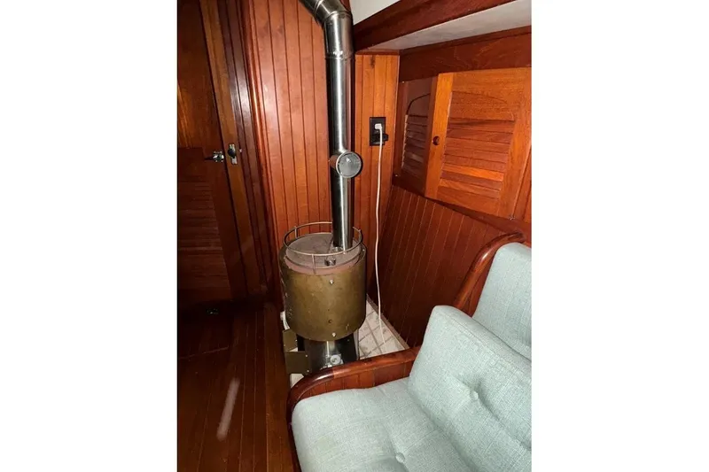 Slide: The Image of Interior of 1986 Crealock 40 sailboat with wood paneling and stove. - 11