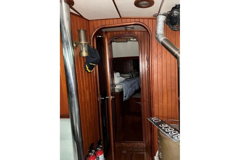 Slide: The Image of Interior of 1986 Crealock 40 sailboat with wood paneling and cozy cabin. - 12