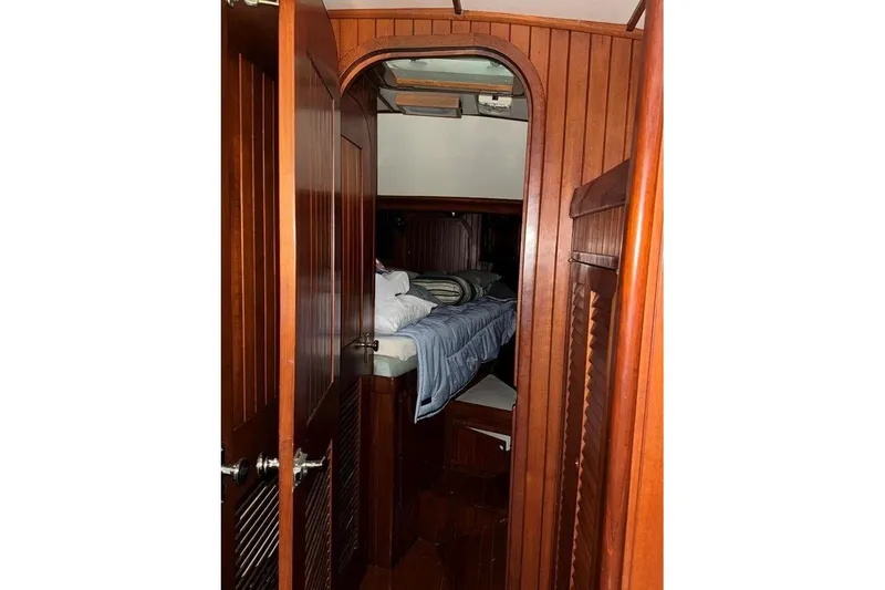 Slide: The Image of Cozy cabin interior of 1986 Crealock 40 sailboat with wooden paneling and bedding. - 17