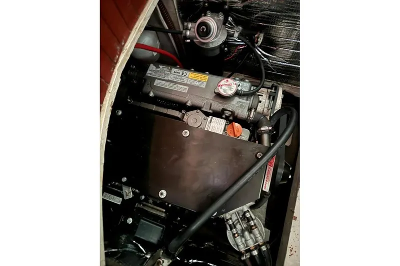 Slide: The Image of Engine compartment of a 1986 Crealock 40 sailboat, showcasing mechanical components. - 23