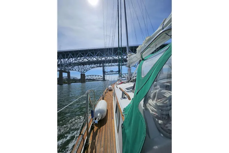 Slide: The Image of Sailing under a bridge on a 1986 Crealock 40 yacht, sunny day. - 4