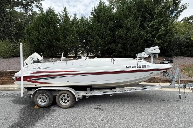 The Image of 2021 Hurricane SunDeck Sport 201 OB boat on trailer, parked on a road. - 0