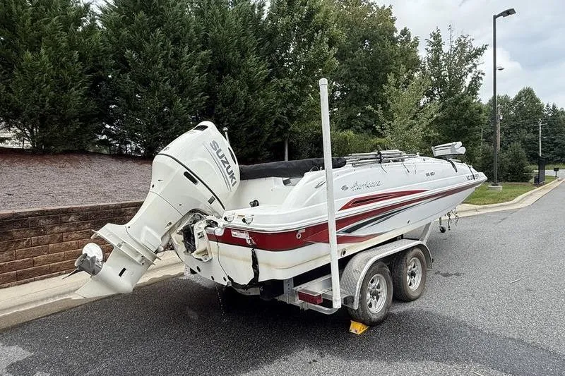 Slide: The Image of 2021 Hurricane SunDeck Sport 201 OB boat on trailer, parked on a street. - 3
