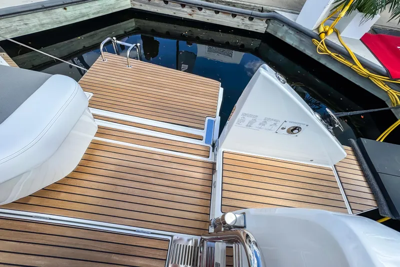 Slide: The Image of 2026 Wellcraft 38 T-Top boat with teak deck and swim platform at dock. - 12