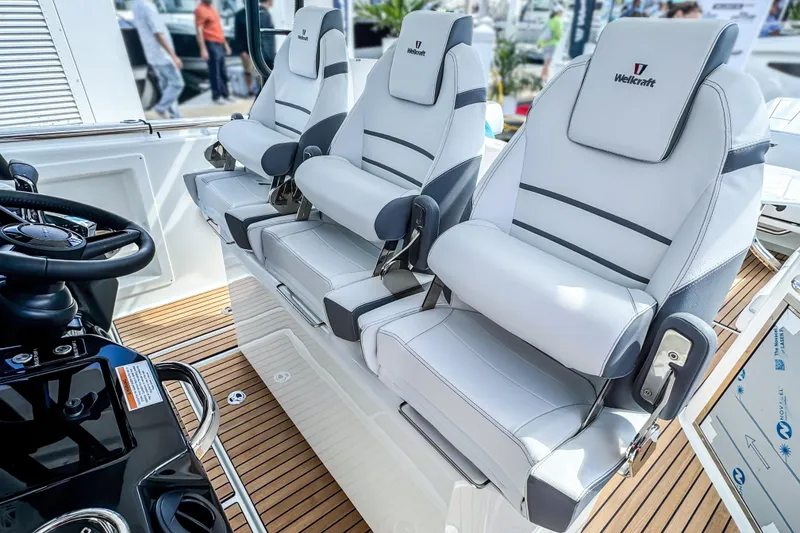 Slide: The Image of 2026 Wellcraft 38 T-Top boat with luxurious white seating and sleek design. - 25