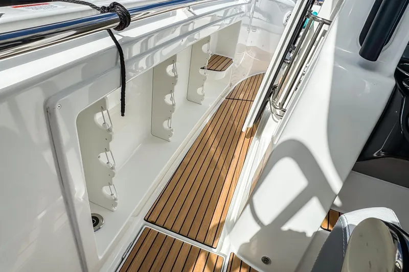 Slide: The Image of 2026 Wellcraft 38 T-Top boat interior with sleek wood flooring and storage compartments. - 30