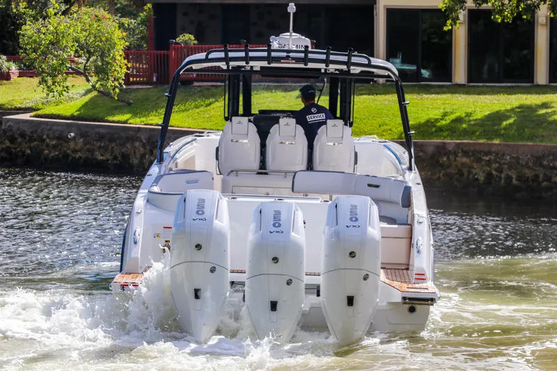 Slide: The Image of 2026 Wellcraft 38 T-Top boat with quad engines cruising on a scenic waterway. - 6