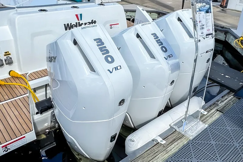 Slide: The Image of 2026 Wellcraft 38 T-Top with triple Mercury 350 V10 engines at dock. - 9