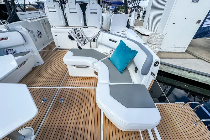 Slide: The Image of Luxurious seating area on 2026 Wellcraft 38 T-Top boat with teak flooring and cushions. - 11