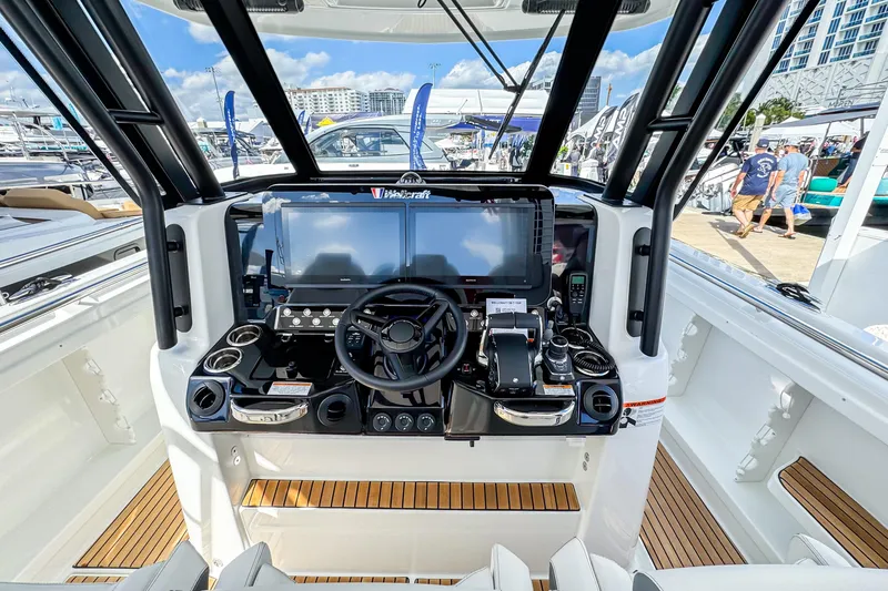 Slide: The Image of 2026 Wellcraft 38 T-Top boat helm with advanced navigation system and sleek design. - 17