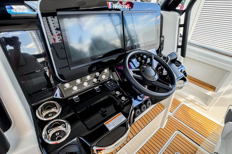 Slide: The Image of 2026 Wellcraft 38 T-Top helm with advanced navigation screens and controls. - 18