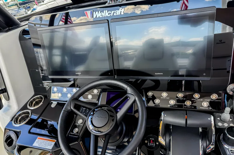 Slide: The Image of 2026 Wellcraft 38 T-Top helm with dual Garmin displays and modern controls. - 20