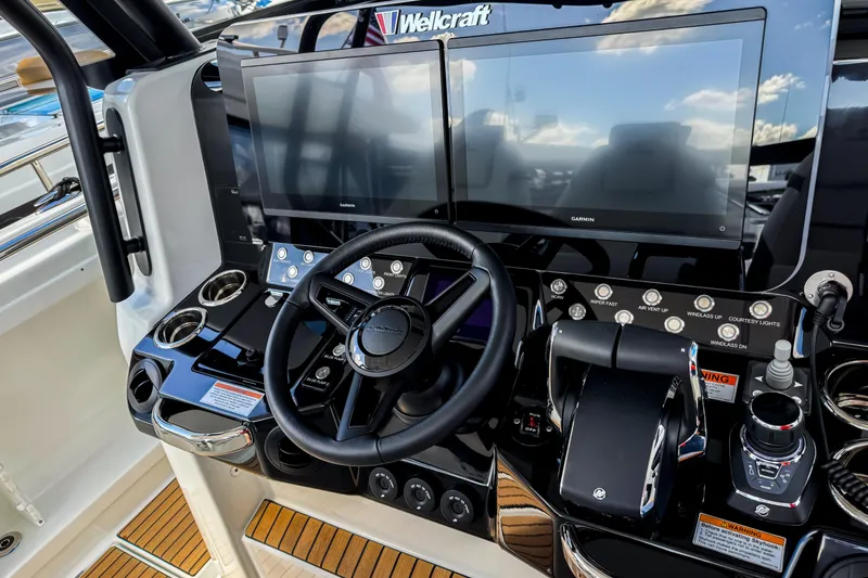 Slide: The Image of 2026 Wellcraft 38 T-Top boat dashboard with dual screens and modern controls. - 21