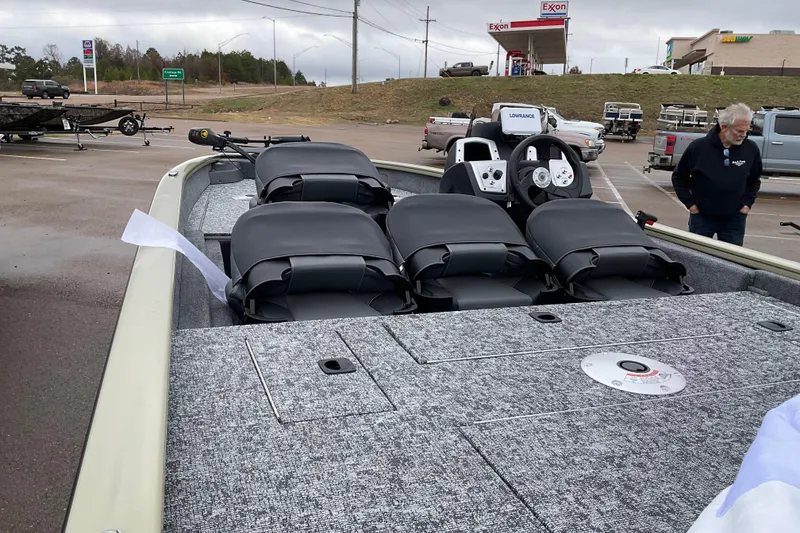 Slide: The Image of 2026 Tracker Pro Team 175 Crappie Edition boat in parking lot, featuring multiple seats. - 2