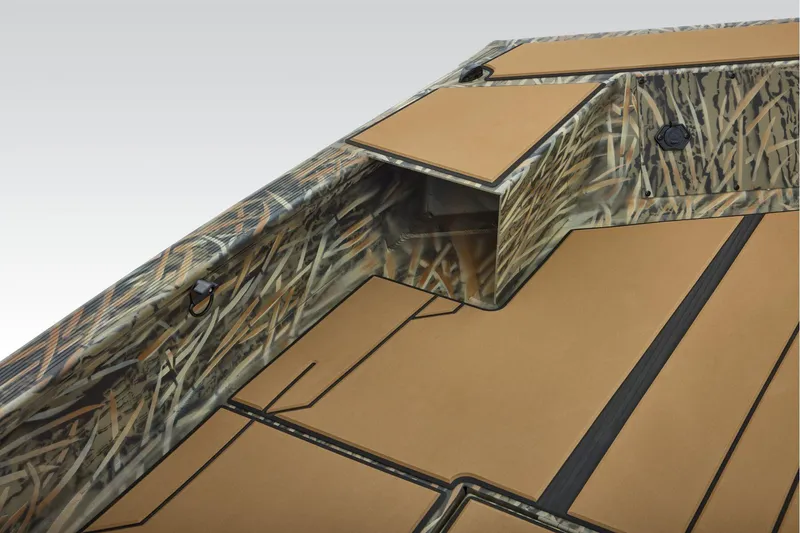 Slide: The Image of 2026 Tracker Grizzly 1756 T Marsh boat with camouflage pattern and drain plug detail. - 12