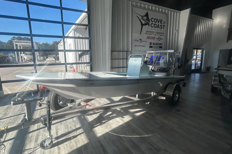 Slide: The Image of 2026 East Cape Evo 17X boat displayed indoors on a trailer. - 0