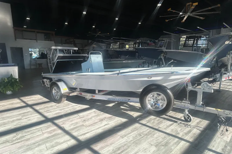 Slide: The Image of 2026 East Cape Evo 17X boat displayed indoors on a trailer. - 1