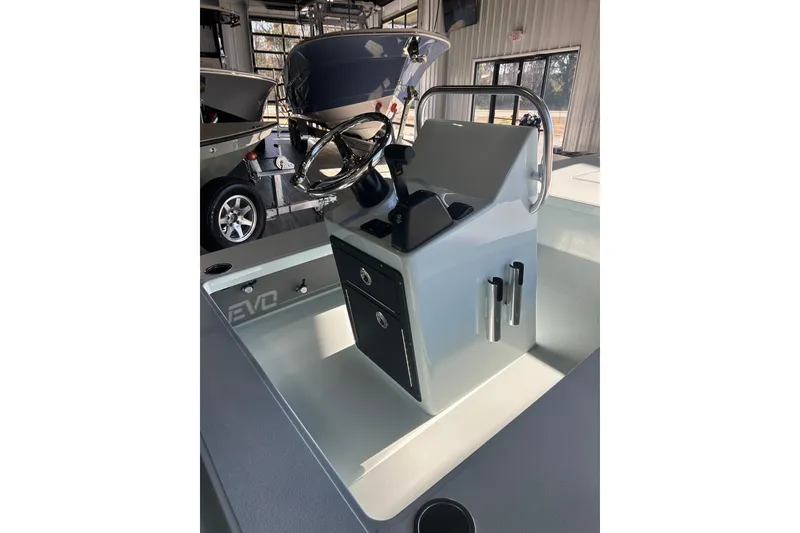 Slide: The Image of 2026 East Cape Evo 17X boat console with steering wheel and storage compartments. - 2