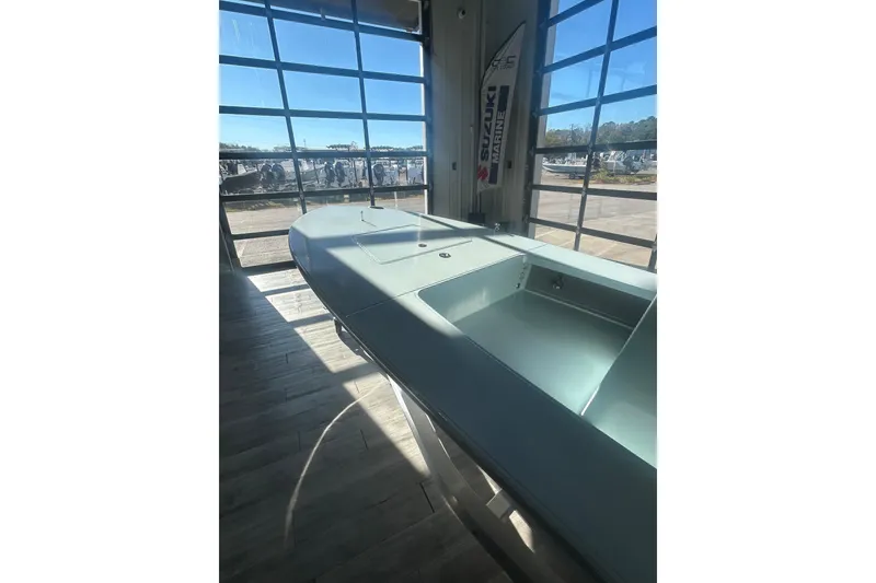 Slide: The Image of 2026 East Cape Evo 17X boat displayed indoors with sunlight streaming through large windows. - 9