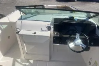 Slide: The Image of 2023 Sea Ray SDX 250 Outboard boat cockpit with steering wheel and dashboard. - 11