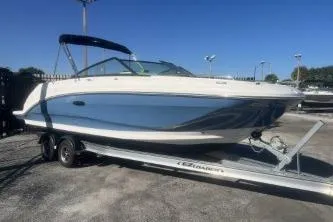 Slide: The Image of 2023 Sea Ray SDX 250 Outboard boat on trailer, parked outdoors. - 4