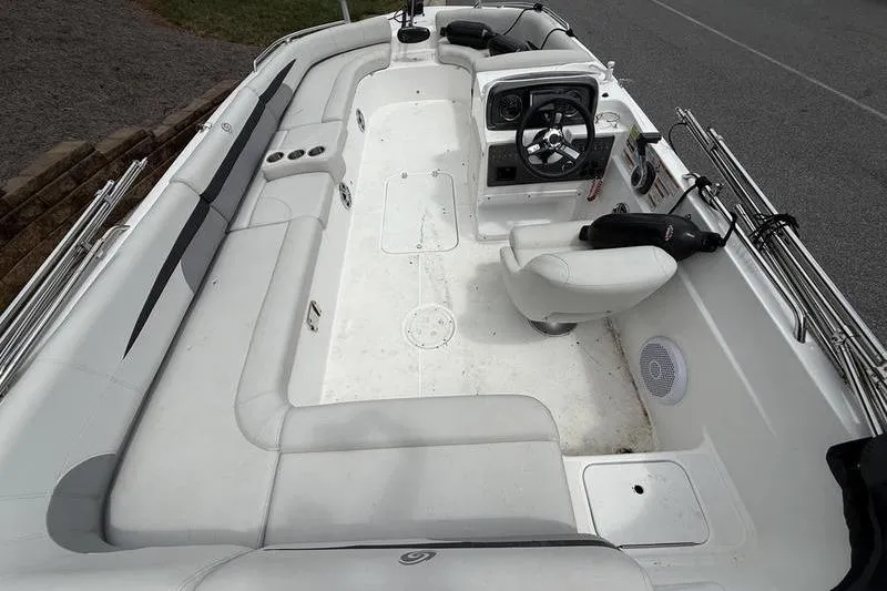Slide: The Image of 2021 Hurricane SunDeck Sport 201 OB boat interior with seating and steering console. - 9