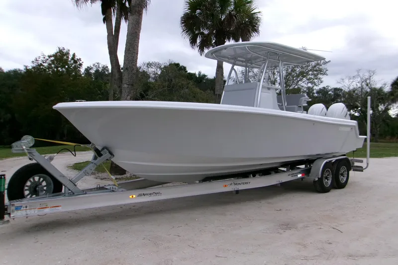The Image of 2026 Contender 28 Tournament boat on trailer, parked outdoors with trees in background. - 0