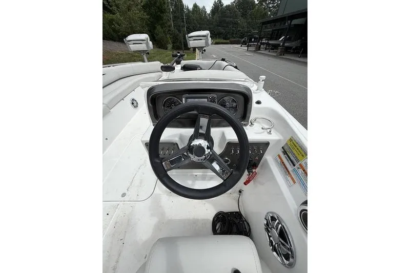 Slide: The Image of 2021 Hurricane SunDeck Sport 201 OB boat dashboard with steering wheel and controls. - 8