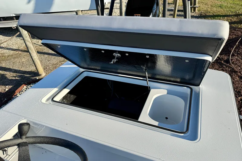 Slide: The Image of 2026 East Cape EVO 17V boat with open storage compartment and steering wheel. - 11