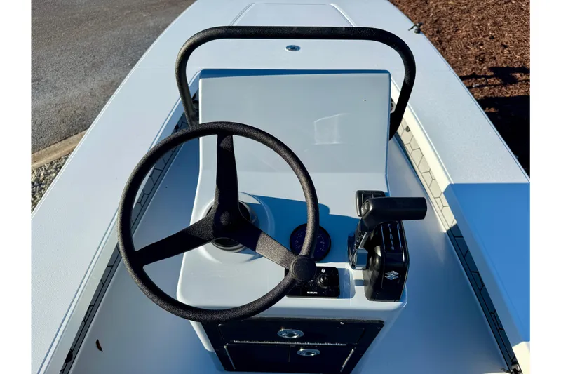 Slide: The Image of 2026 East Cape EVO 17V boat console with steering wheel and controls. - 7