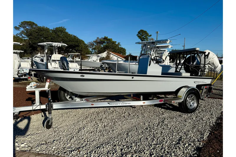 The Image of 2026 East Cape EVO 17V boat on trailer, parked outdoors under clear blue sky. - 0
