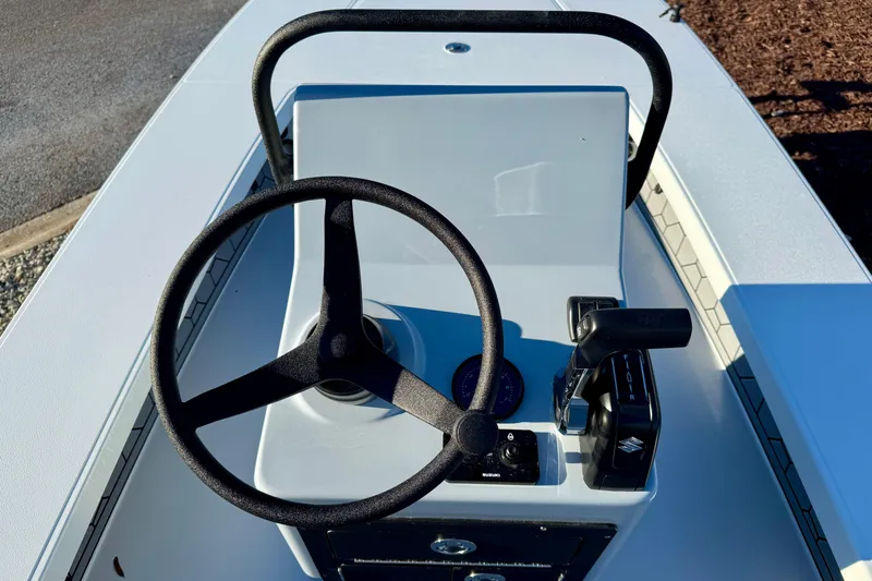 Slide: The Image of 2026 East Cape EVO 17V boat console with steering wheel and controls. - 13