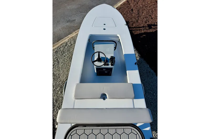 Slide: The Image of 2026 East Cape EVO 17V boat interior with steering console and seating. - 14