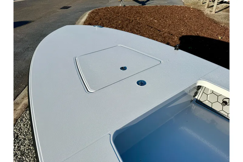 Slide: The Image of 2026 East Cape EVO 17V boat deck with storage hatch, sleek design. - 8