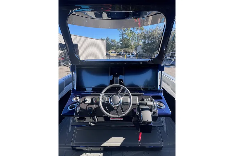 Slide: The Image of 2026 Mystic Powerboats M3800 helm with modern controls and dual screens. - 10