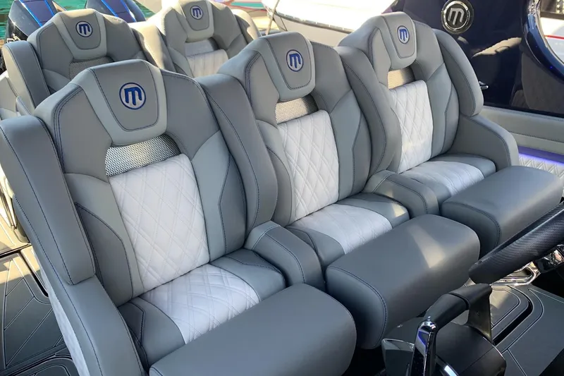 Slide: The Image of Luxurious seating in 2026 Mystic Powerboats M3800, featuring elegant gray and white upholstery. - 8