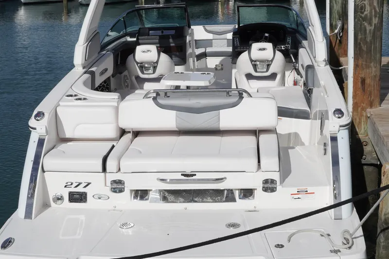 Slide: The Image of 2019 Chaparral 227 SSX boat with luxurious white seating and sleek design at the dock. - 9