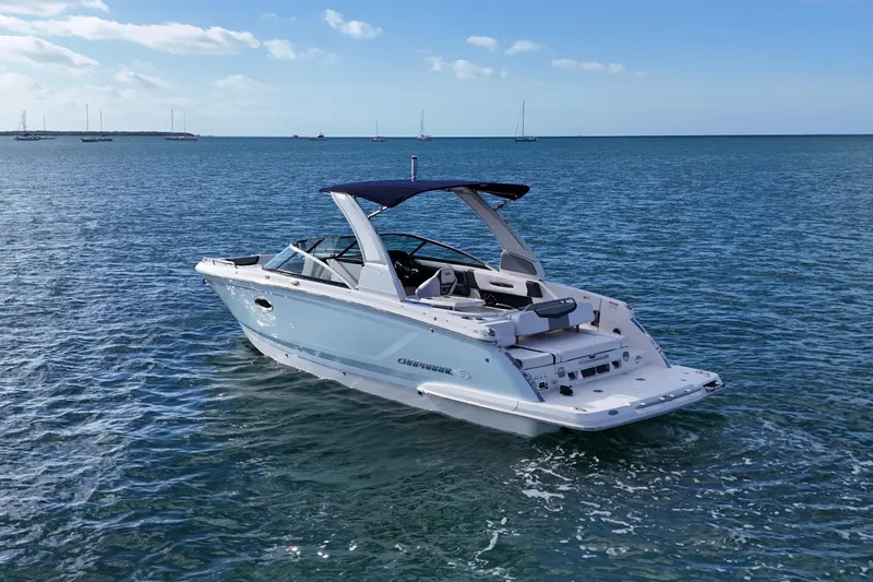 Slide: The Image of 2019 Chaparral 227 SSX boat on calm ocean waters under a clear sky. - 2