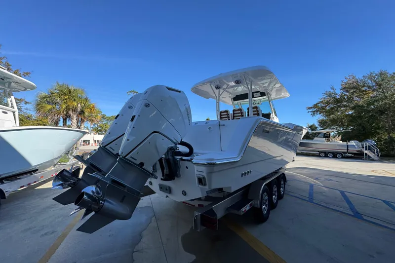Slide: The Image of 2026 Bertram 34 CC boat with dual outboard engines on a trailer. - 14