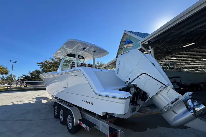 Slide: The Image of 2026 Bertram 34 CC boat on trailer, featuring powerful Mercury outboard engine. - 18