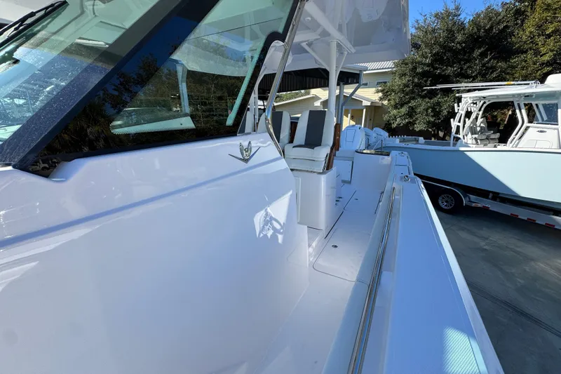 Slide: The Image of 2026 Bertram 34 CC boat with sleek white exterior and modern design features. - 26