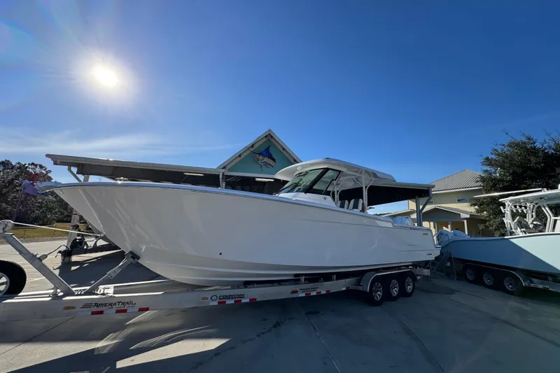 Slide: The Image of 2026 Bertram 34 CC boat on trailer under sunny sky. - 3