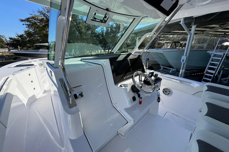 Slide: The Image of 2026 Bertram 34 CC boat cockpit with modern steering and navigation controls. - 31