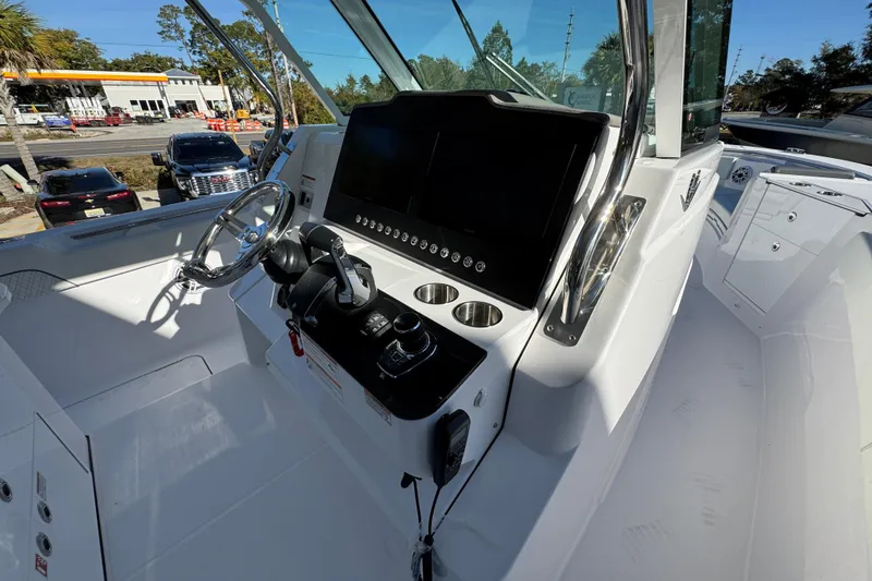 Slide: The Image of 2026 Bertram 34 CC boat cockpit with modern steering and control panel. - 34