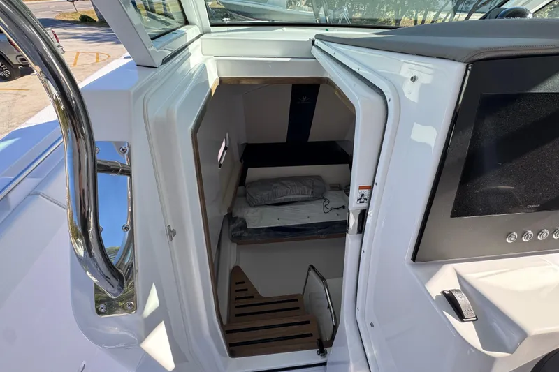 Slide: The Image of 2026 Bertram 34 CC cabin interior with stairs and bedding. - 35