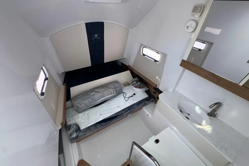 Slide: The Image of 2026 Bertram 34 CC cabin interior with bed, sink, and modern design elements. - 36